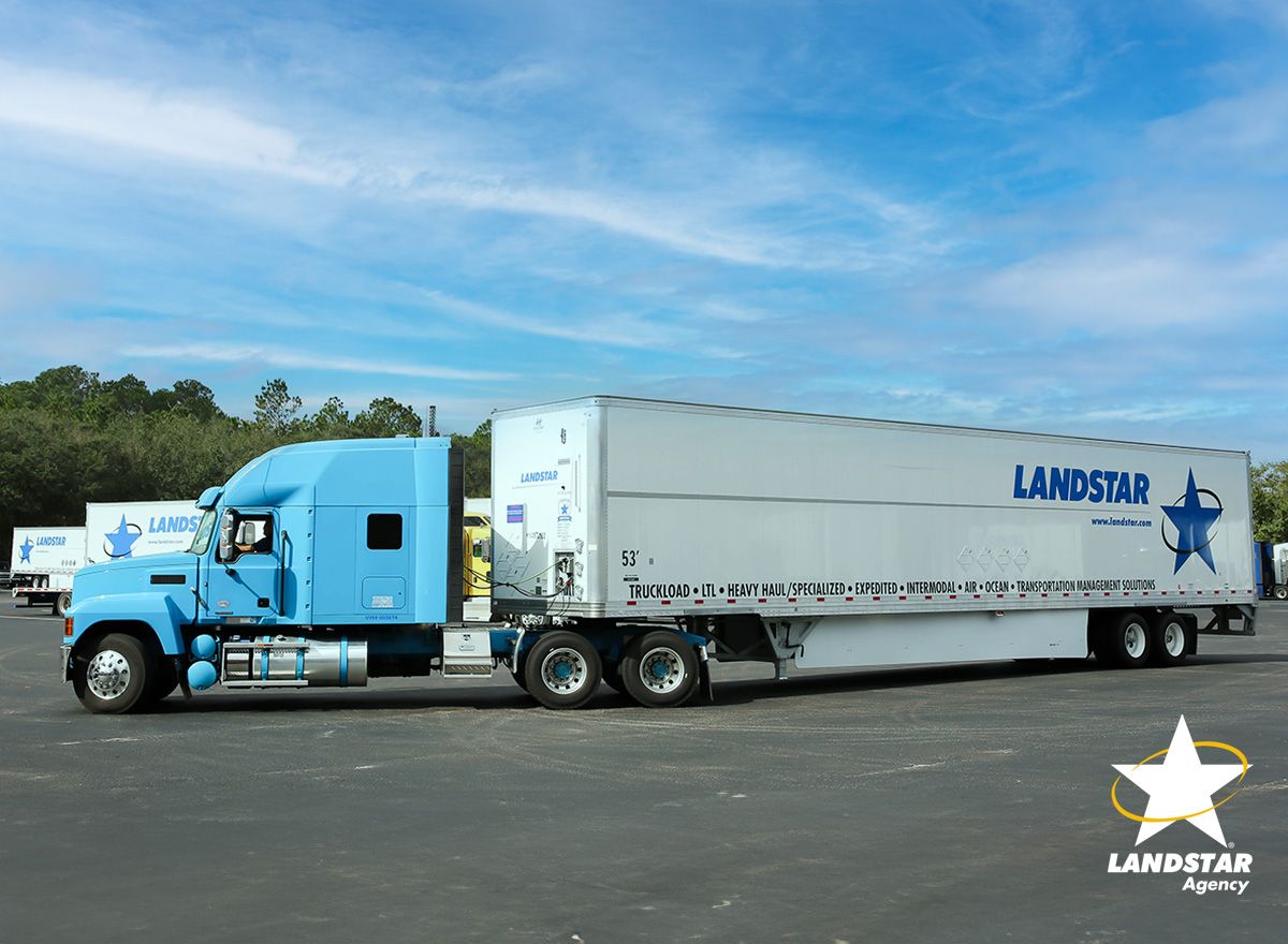 Landstar tractor-trailer staged in a yard, ready for dispatch