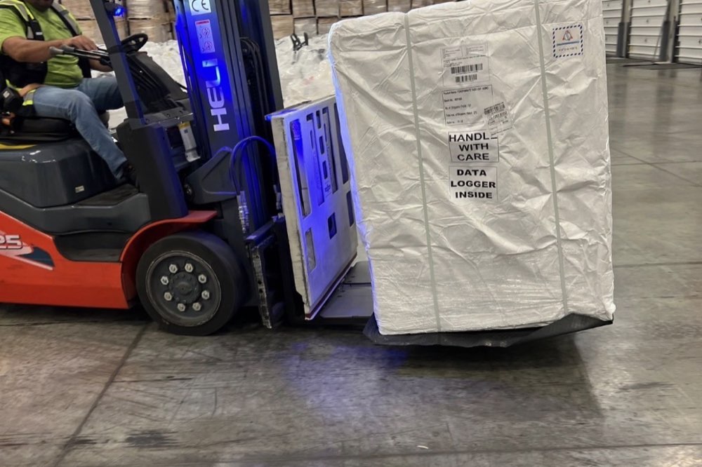 Temperature-sensitive cargo with a data logger being handled by forklift
